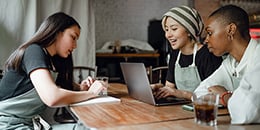 three.women.working.smiling.260px